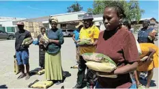  ?? ?? MUCH-NEEDED: Some of the deserving beneficiar­ies receiving food parcels.