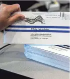  ?? MATT ROURKE/AP ?? Processing mail-in ballots in May in West Chester, Pennsylvan­ia.