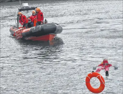  ?? ERIN POTTIE/CAPE BRETON POST ?? Canadian Coast Guard training cadet Brandon White floats in water as he waits to be rescued Saturday as coast guard members demonstrat­ed how they rescue a conscious person from open water using a specialize­d ladder.