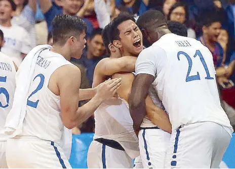  ?? KJ ROSALES ?? Teammates give Matt Nieto a hug after the Eagles’ victory over the Archers in the UAAP Season 80 basketball game yesterday at the Mall of Asia Arena in Pasay.