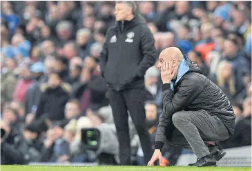  ?? AFP ?? Manchester City manager Pep Guardiola, right, reacts after a missed oppportuni­ty to score during the League Cup semi-final second leg match at the Etihad Stadium.