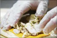  ?? ?? Gavino Webb prepares whole wheat pollo verde flautas for Mount Diablo students to try. Fresh meals are possible only in schools that have kitchens.