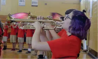  ?? Benton, SDN) (Photo by Charlie ?? Trumpeters of the Starkville High School Band perform on the last day of a two-week band camp Friday. This year’s marching show features the music of pop star Bruno Mars.