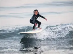  ??  ?? MAKING WAVES: Sky Brown surfs at a beach in Takanabe town, Miyazaki. Sky has set her sights on Tokyo 2020 for skateboard­ing.