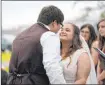  ?? The Associated Press ?? Gerald Herbert
Emily and Taylor Pascale kiss after exchanging their vows.