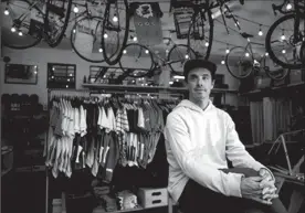  ?? TRIBUNE NEWS SERVICE ?? Sean Talkington, owner of Team Dream cycling apparel, is shown in his shop in a old converted gas station on Jan. 3 in San Marino. His high-end bike apparel is being counterfei­ted on Chinese e-commerce sites.