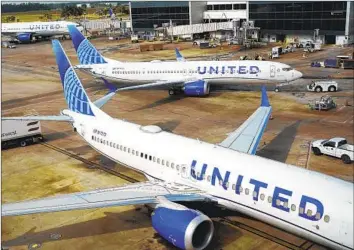  ?? David J. Phillip Associated Press ?? DAYS AFTER a midair incident involving an Alaska Airlines Boeing 737 Max 9 jet, United Airlines found loose bolts and other door plug issues when examining its own f leet of the planes, which are now grounded.