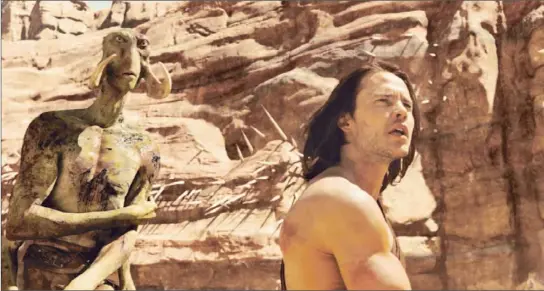  ?? Photograph­s by Frank Connor
Disney ?? TAYLOR KITSCH stars as John Carter, a Confederat­e soldier transporte­d to Mars, where he encounters Tars Tarkas, left, a CG creation around actor Willem Dafoe.