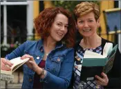  ??  ?? Aisling and Eilish Wrenn from Listowel enjoy a book during Writers’ Week.