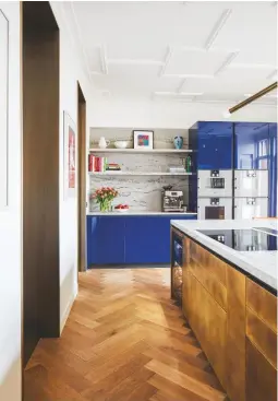  ??  ?? KITCHEN
Life revolves around this shiny, happy space. ‘The last time I visited the family, their sons had taken over the kitchen and were cooking up a storm,’ says Peter. The blue is uplifting. Kitchen, Boffi with Carrara marble worktops and a brass island