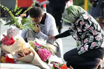  ?? Fiona Goodall/Getty Images ?? Mourners lay flowers near the Al Noor Mosque in Christchur­ch, New Zealand, in tribute to the 49 people who were killed Friday.
