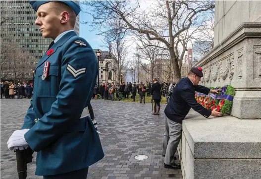  ?? DAVE SIDAWAY ?? Master Warrant Officer Volker Kock lays a wreath at the Place du Canada cenotaph during a Remembranc­e Day ceremony attended by thousands. “It’s emotional,” said Ronald Gagnon, who served with the Royal 22nd Regiment for 32 years. “You think about all the comrades you lost.”