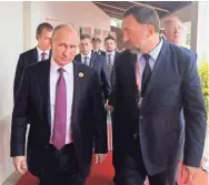  ?? KREMLIN POOL PHOTO VIA AP ?? Russian President Vladimir Putin, left, and metals magnate Oleg Deripaska arrive at a forum last year in Vietnam. Deripaska is among oligarchs targeted in new U.S. sanctions Friday.