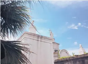  ??  ?? St. Louis Cemetery No. 1 in New Orleans shows its above ground burial vaults pictured against a blue sky. The vaults are laid out like little houses in maze-like aisles that feel like tiny streets. Some tombs are decorated with sculptures and crosses. Many are in a picturesqu­e state of decay.