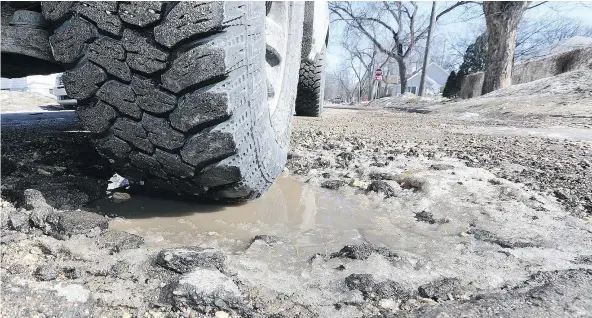  ?? — POSTMEDIA NEWS FILES ?? Don’t swerve to avoid a pothole, but rather keep both hands on the wheel and drive through it, says one auto expert.