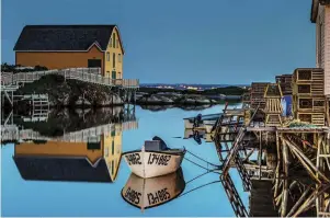  ?? CATEGORY WINNER | LANDSCAPES Michael Winsor ?? A perfectly calm evening produces vivid reflection­s at the Barbour Living Heritage Village in the riding of Bonavista-burin-trinity, N.L.