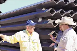  ?? ALGERNON D’AMMASSA/LAS CRUCES SUN-NEWS ?? U.S. Rep. Ralph Norman, R-S.C., left, speaks with New Mexico ranchers Bill Hooper and Scott Chandler on Monday at a site where wall constructi­on materials are stockpiled in Luna County near the U.S.-Mexico border.