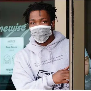  ??  ?? A man leaves a convenienc­e store Thursday in Houston, Texas, where the coronaviru­s has spread rapidly, taxing the city’s hospital capacity.
(AP/David J. Phillip)