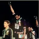  ??  ?? Tommie Smith, centre, and John Carlos, right, were sent home for giving the black power salute at the 1968 Olympic Games.