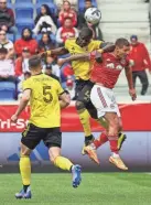  ?? VINCENT CARCHIETTA/USA TODAY SPORTS ?? Crew defender Jonathan Mensah battles for a ball against Red Bulls forward Patryk Klimala on Sunday.