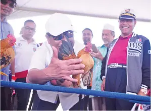  ??  ?? (Gambar bawah) YAHYA tertarik dengan keunikan postur badan ayam serama yang dipamerkan semasa karnival.