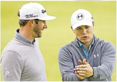  ?? GETTY ?? Dustin Johnson bashes drive on fourth hole (at r.) during opening round of British Open on Thursday, then talks shop with Jordan Spieth on the 18th green. Johnson leads by 1 stroke after firing a 65, but Spieth, holder of the year’s first two majors,...