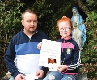  ?? Photo by Michelle Cooper Galvin ?? Tiffany O’Brien with a letter from Pope Francis, which she received for what was to be her Holy Communion Day. With father, Richard, at home of Ballyspill­ane.