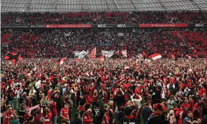  ?? Photograph: Ralf Treese/DeFodi Images/REX/ Shuttersto­ck ?? Bayer Leverkusen supporters flooded the pitch at full-time as the title was confirmed.