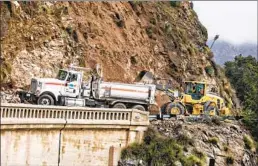  ?? Jason Armond Los Angeles Times ?? CALTRANS EMPLOYEES work to reopen State Route 39 after mudslides and rockslides closed the road in both directions near Morris Dam in Azusa.