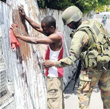  ?? FILE ?? A soldier conducts a search in Spanish Town, St Catherine.