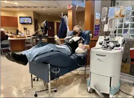  ?? PHOTOS BY REBEKAH LUDMAN — ENTERPRISE-RECORD ?? Larry Ducommun reads a book while donating plasma Tuesday at Vitalant in Chico.