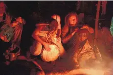  ??  ?? Women beat a drum in a drum circle at the annual Rainbow Gathering. Last July 4, regulars joined one another online to “ohm from home.”