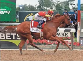  ?? AP ?? Justify, with jockey Mike Smith up, crosses the finish line to win the 150th running of the Belmont Stakes horse race, Saturday in Elmont, N.Y.