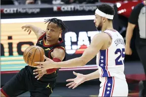  ?? RON SCHWANE — THE ASSOCIATED PRESS ?? Isaac Okoro battles the 76ers’ Ben Simmons for a rebound April 1at RocketMort­gage FieldHouse.