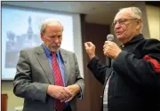  ?? NWA Democrat-Gazette/CHARLIE KAIJO ?? Paul Dolle (right) of Gravette shares his opinion about the Confederat­e statue next to moderator Jon Comstock. Community members discussed opinions on the statue in Bentonvill­e’s square and what should be done about it.