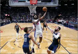  ?? GERALD HERBERT — THE ASSOCIATED PRESS ?? Detroit Pistons forward Marvin Bagley III (35) goes to the basket over New Orleans Pelicans guard Dyson Daniels (11) and center Jonas Valanciuna­s (17) in the first half in New Orleans, Wednesday.