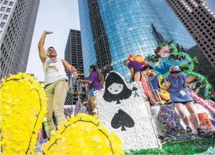  ?? Brett Coomer / Houston Chronicle ?? Parade participan­ts acknowledg­e the crowd during the annual Pride Parade on Saturday. The parade was led by Mayor Sylvester Turner and included most of the Houston Police Department’s command staff along with a specially decked-out police SUV.