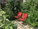  ??  ?? Above: In a small front yard these chairs are hidden behind rose-of-Sharon and sunflowers, but there’s still an opening out to the sidewalk.