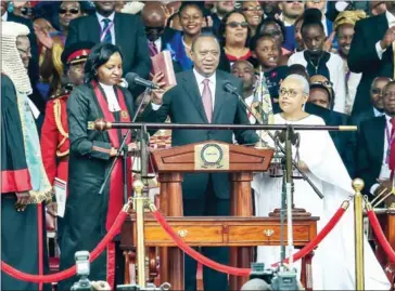  ??  ?? Kenya’s President Uhuru Kenyatta takes oath of office during his inaugurati­on ceremony at Kasarani Stadium yesterday in Nairobi.