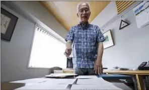  ?? AP/EUGENE HOSHIKO ?? Bookstore owner Takeo Hatano displays the “Yuzawa memo” that he discovered nine years ago but kept secret until now “as I was afraid of a backlash” over its contents.