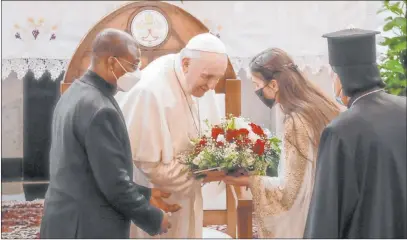  ?? Andrew Medichini The Associated Press ?? Pope Francis is welcomed Friday upon his arrival at Sayidat al-nejat cathedral in Baghdad.