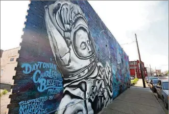  ??  ?? A new mural dedicated to NASA astronaut Charles Bassett II has been installed at the corner of Wyandot and Third streets in downtown Dayton.