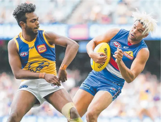  ?? Picture: GETTY IMAGES ?? Western Bulldogs star Jason Johannisen (right) bounces off the shoulder of West Coast’s Willie Rioli at Etihad Stadium.