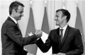  ?? PHOTO: AP ?? Greek Prime Minister Kyriakos Mitsotakis (left) and French President Emmanuel Macron shake hands after the signing of a new defence deal at The Elysee Palace on Tuesday
