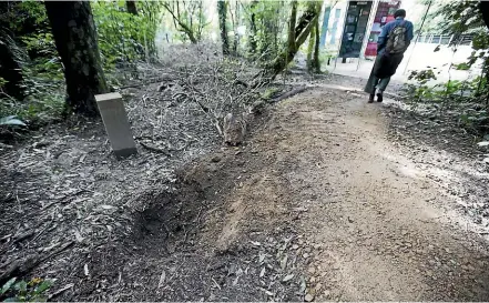  ?? PHOTOS: MURRAY WILSON/STUFF ?? Thieves uprooted a donation box at the Ballance Domain entrance of the Manawatu¯ Gorge walking track, and dragged it through the gateway on Sunday.