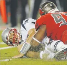  ?? The Associated Press ?? Patriots quarterbac­k Tom Brady is sacked by Buccaneers defensive tackle Gerald McCoy on Thursday.