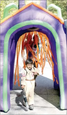  ?? Keith Bryant/The Weekly Vista ?? Bella Vista resident Dax Jones, 5, walks through a witchy inflatable doorway at the library entrance. This was his first year at the event and Jones did not appear to fear ghosts.