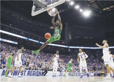  ??  ?? Oregon’s Jordan Bell dunks against Kansas in the Midwest Regional title game Saturday. Oregon will be playing in the Final Four for the first time since 1939, when it won the first NCAA Tournament.