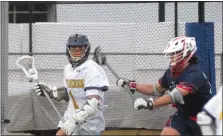  ?? ED MORLOCK - MEDIANEWS GROUP ?? Upper Merion’s Casey Lamey carries the ball behind the net while Holy Ghost Prep’s Charles Walker defends on Wednesdsay.