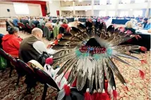  ??  ?? Jesse Nightwalke­r, of Tacoma, Washington, a member of the Palouse tribe, wears a ceremonial headdress as he attends a meeting of the Southern Resident Killer Whale Recovery Task Force.